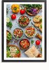 Een prachtige ingelijste foto, perfect als wanddecoratie, toont een assortiment verse groenten en salades. Kommen gevuld met kleurrijke gehakte groenten worden omringd door hele paprika's, tomaten, plakjes komkommer, kruiden, brood en een pepermolen - ideaal voor gebruik met een Colourful Dishes Schilderij van CollageDepot.,Zwart-Met,Lichtbruin-Met,showOne,Met